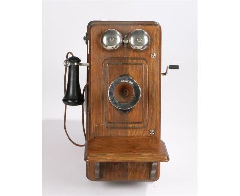 Kellogg wooden cased wall mounted telephone circa 1910, with mouth piece to the left hand side, crank handle to the right han