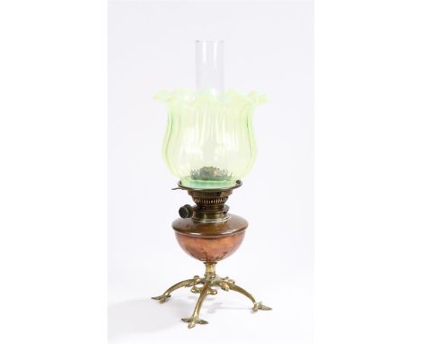 In the style of W.A.S. Benson, a brass & copper oil lamp, with vaseline glass shade, the lamp fitting marked Harrods Stores M