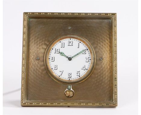 Early 20th Century desk clock, the engine turned brass case with a white enamel dial and Arabic hours, easel to the base, the