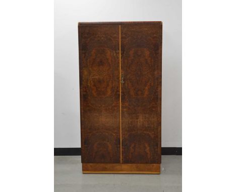 A 20th century art deco style burr walnut veneered compactum/wardrobe, by Enfurn, the doors with a shell handle, enclosing fi