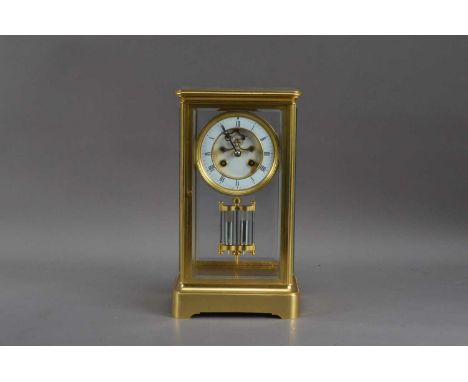An early 20th century French brass four glass striking mantle clock, the circular dial with Roman Numerals (some damage), the