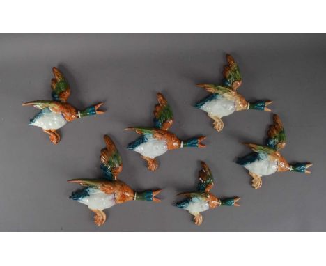 A collection of ceramic graduated Beswick wall mounted ducks, comprising one 596/1, 26cm in length, four 596/2 and one 596/3,