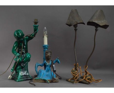 A collection of four lamps, comprising a green ceramic example of a child, AF 49.5cm high, a damaged Chinese example, and a p