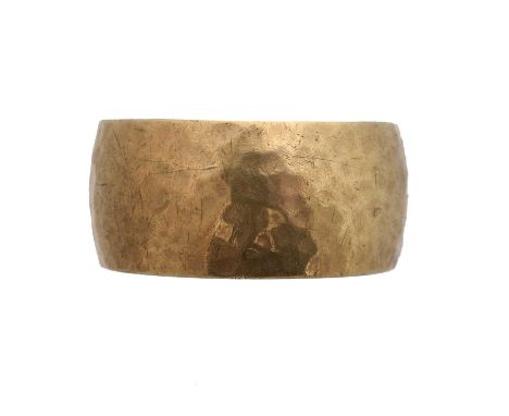 A 9ct gold band ring by David M Robinson. Of planished design, sponsor's marks DMR for David M Robinson, hallmarks for London