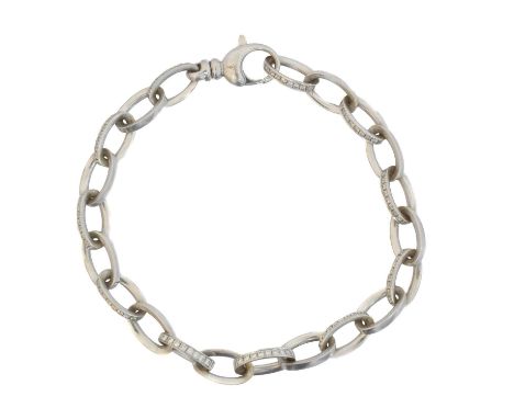 An 18ct gold diamond bracelet by Theo Fennell. Designed as a trace link chain with alternating diamond-set and polished links