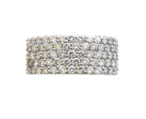 An 18ct gold diamond band ring. The brilliant cut diamond band with tapered shoulders, estimated total diamond weight 1.25cts