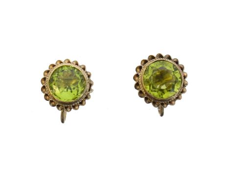 A pair of peridot stud earrings. Each designed as a circular shape peridot within a wirework surround, hallmarks for Birmingh