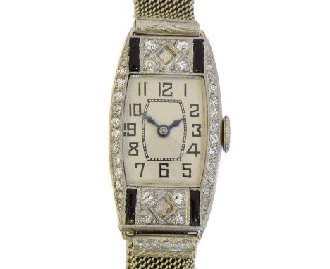 An early 20th century French platinum cocktail watch. The tonneau shape dial with arabic markers and inner chapter ring, manu