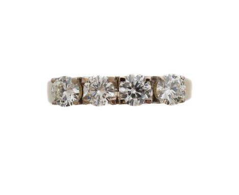 A diamond four stone ring. The brilliant cut diamond line within four claw settings, total diamond weight 1ct, stamped to ban