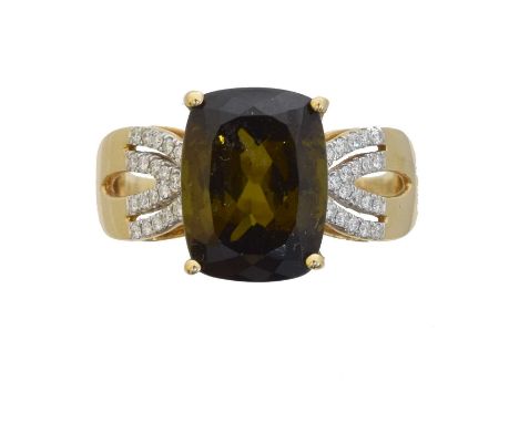 An 18ct gold tourmaline and diamond dress ring, by Lorique. The cushion shaped green-brown tourmaline weighing 5.50cts with b