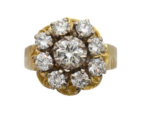 A 1970s diamond cluster ring, attributed to Abe Pass. The brilliant cut diamond within a similarly cut diamond surround, set 
