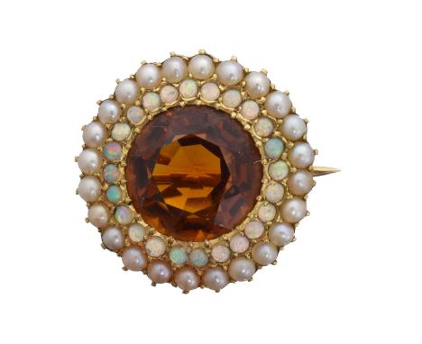 A gem set brooch. The circular shape citrine within an opal and split pearl surround, length 1.9cm, gross weight 3.9g.