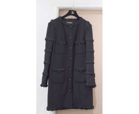 A Chanel wool jacket. With pleated ribbon decoration to arms, neckline, hem and pockets, gun metal grey gilt decoration to bu
