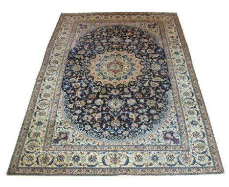 VERY FINE PERSIAN NAIN CARPET, 300cm x 215cm, star medallion on a midnight blue field of scrolling vines and palmettes inside