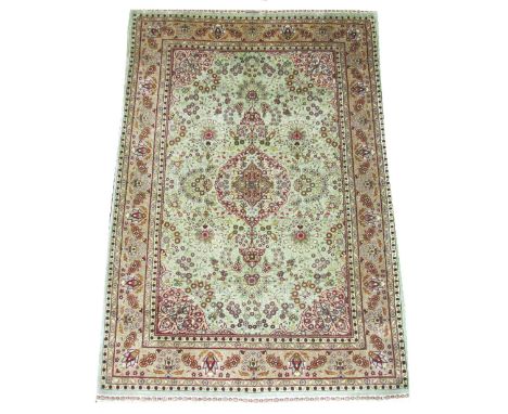 EXTREMELY FINE SIGNED SILK HEREKE RUG, 150cm x 103cm, pole medallion on a jade field of flowerheads, vines and foliage within