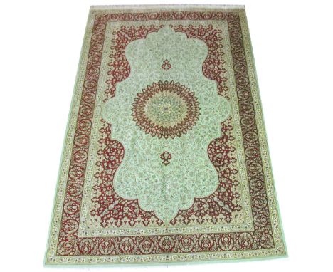 EXTREMELY FINE SIGNED PERSIAN SILK QUM RUG, 208cm x 135cm, organic medallion on a cartouche jade field of scrolling vines and