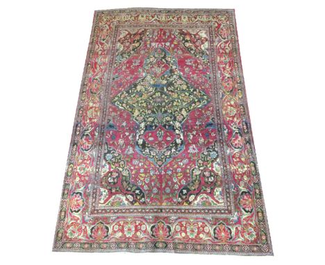 ANTIQUE PERSIAN ISFAHAN CARPET, 218cm x 140cm, organic medallion on a ruby field of palmettes and vines, within corresponding