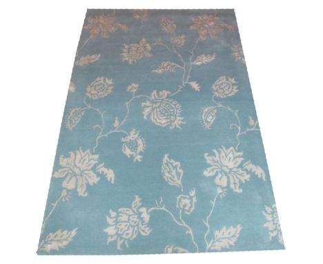 CONTEMPORARY CARPET, 250cm x 160cm, floral designs in sky blue and ivory. 