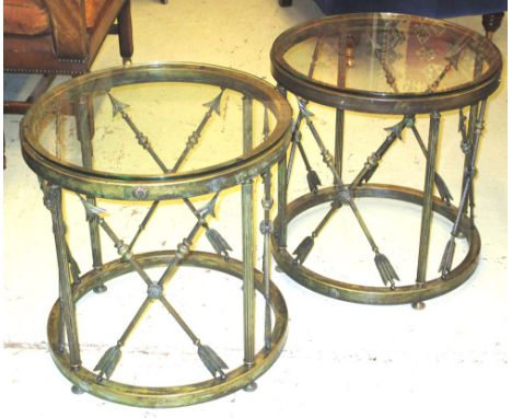 LOW TABLES, a pair, early 20th century Empire style brass with circular glass tops and crossed arrow supports, 53cm H x 50cm.