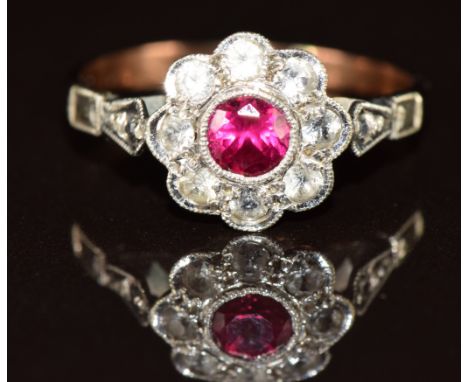 A 9ct gold ring set with a synthetic ruby surrounded by quartz, 1.7g, size K