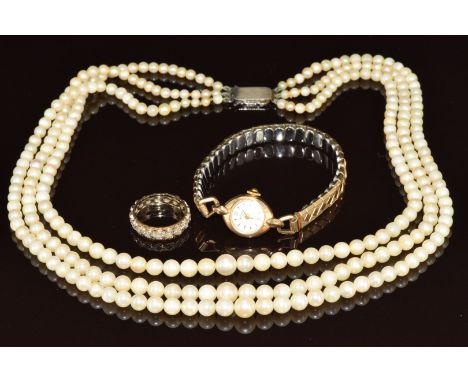 A 9ct gold watch three strand cultured pearl necklace with silver clasp and 9ct gold eternity ring set with spinel