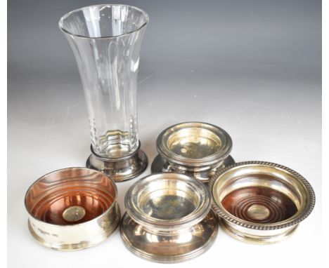 Modern hallmarked silver mounted items comprising two candle holders, two wine bottle coasters and a trumpet shaped glass vas