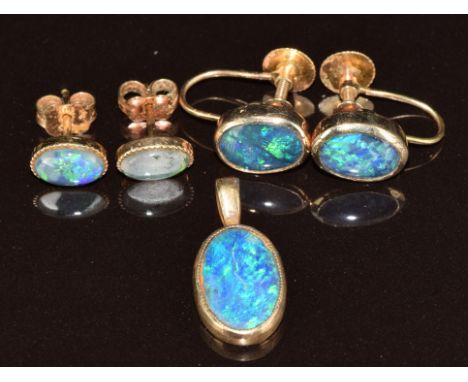 A 9ct gold pendant and earrings set with black opal triplets and another pair of opal earrings, 4.3g
