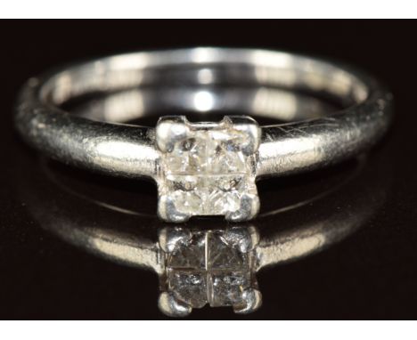 A platinum ring set with four princess cut diamonds, the total diamond weight approximately 0.2ct, 4.3g, size O