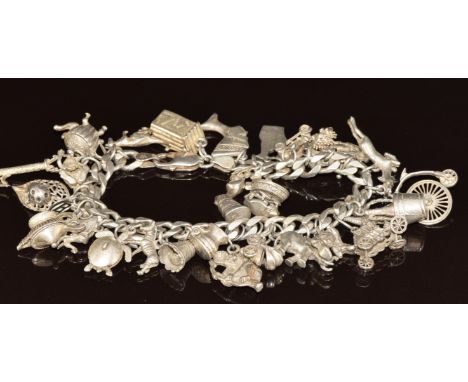 A silver charm bracelet with over 30 charms including Champagne, elephant, boat, etc, 96g&nbsp;