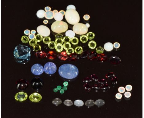 A collection of loose gemstones including two oval cut peridot (totalling approximately 2.1ct), nineteen peridot cabochons (t