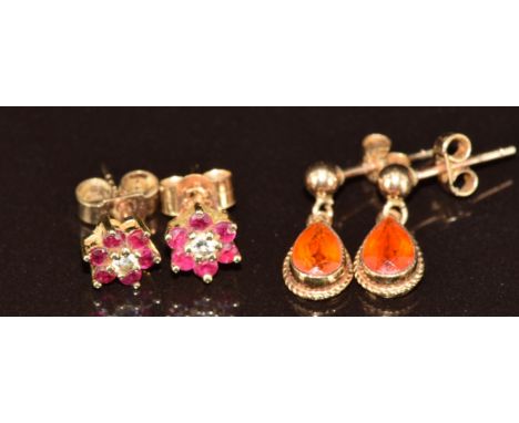 Two pairs of 9ct gold earrings, one set with fire opal and the other a diamond surrounded by rubies, 1.9g&nbsp;