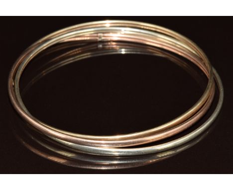 A 9ct gold tri-coloured bangle, 9.3g, 6.8cm