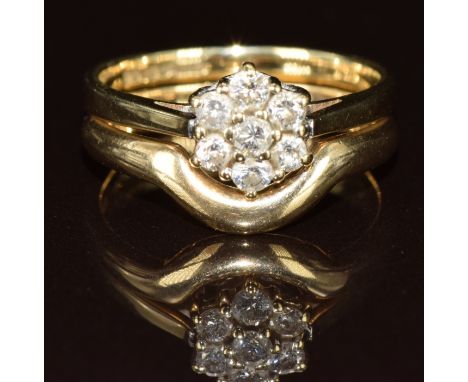 A 9ct gold ring set with diamonds in a cluster and a fitted 9ct gold wedding band / ring, 2.9g, size I