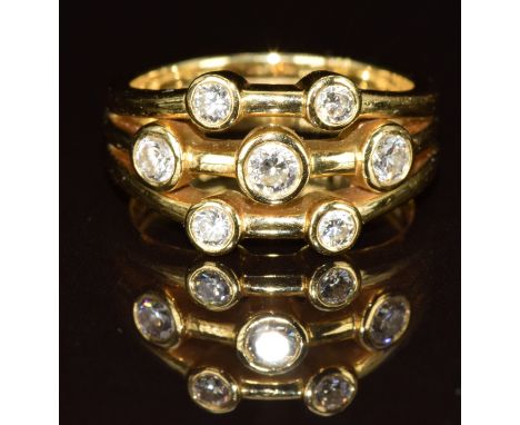 An 18ct gold eternity ring set with seven round cut diamonds, the total diamond weight approximately 0.55ct, originally purch