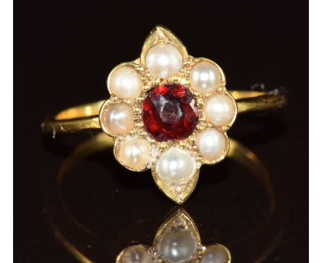 An 18ct gold ring set with a garnet surrounded by split pearls, 2.6g, size L