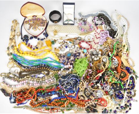 A collection of jewellery including ten silver rings, two 9ct gold rings (3g), beaded necklaces, vintage brooches including C