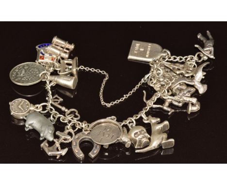 A silver charm bracelet with twenty eight silver charms including Champagne, horseshoe, kangaroo, dog, St Christopher, etc, 4