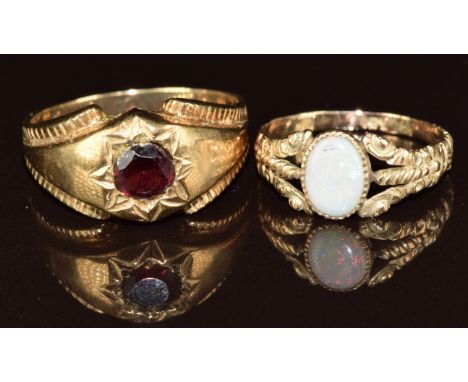 A 9ct gold ring set with a garnet (size U) and a 9ct gold ring set with an opal (size M), 5.6g