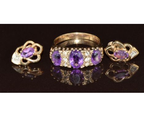 A 9ct gold ring set with amethysts, with similar earrings, 7g, size R