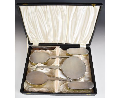 Mappin and Webb cased hallmarked silver dressing table set with engine turned decoration, comprising hand mirror, four brushe