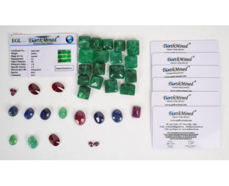 A collection of loose gemstones including 18 emerald cut emeralds (378ct), three oval emeralds (21.6ct), oval cut ruby (21.2c