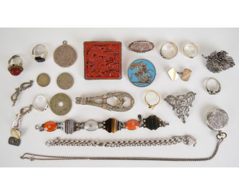 A collection of silver jewellery, rings including buckle and a Chinese example set with cinnabar lacquer (28g), Victorian aga