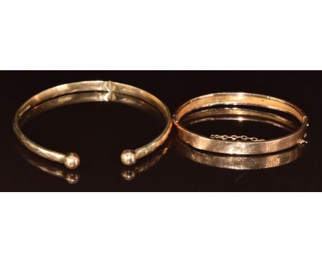 A 9ct rose gold bangle engraved 'Lilla' and a 9ct flapper bangle with faceted decoration, Birmingham 1925, 13.4g