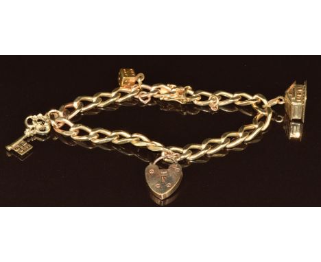 A 14k gold charm bracelet with three 14k gold charms including a key, house opening to reveal two enamel hearts and a die (26