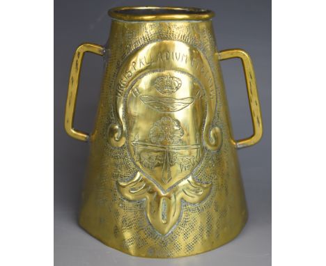 Arts &amp; Crafts conical twin handled brass tankard, repouss&eacute; decorated with coat of arms and Urbis Palladium Et Gent