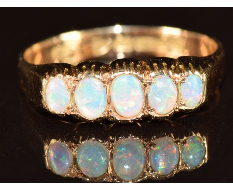 A 15ct gold ring set with five opal cabochons, Chester 1911, 2.1g, size N
