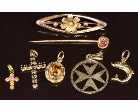 An 18k gold cross pendant set with sapphires (1.2g), 18k gold cross charm/ pendant (0.4g), 14k gold dolphin pendant (0.7g), t