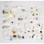 A collection of loose gemstones including agate, howlite, onyx, labradorite, amber, onyx and tiger's
