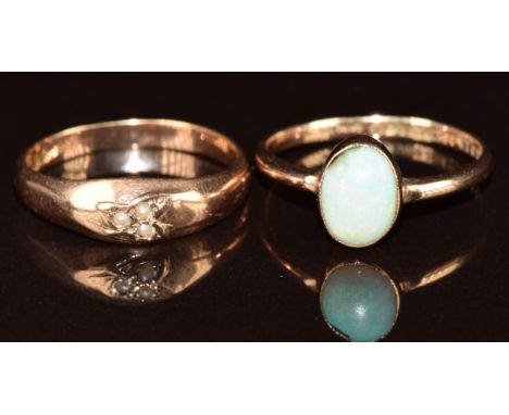 Two 9ct rose gold rings, one set with three seed pearls the other set with an opal (chipped), 3.5g, size L/M &amp; N