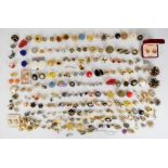 Sixty-five pairs of vintage earrings including Trifari, Monet, Ciro, Carolina Herrera, Joan